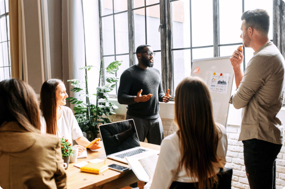 A group of employees having a discussion around a table